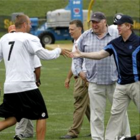 NFL Commissioner Roger Goodell reaches out to shake hands with Ben during morning practice as John Madden looks on.